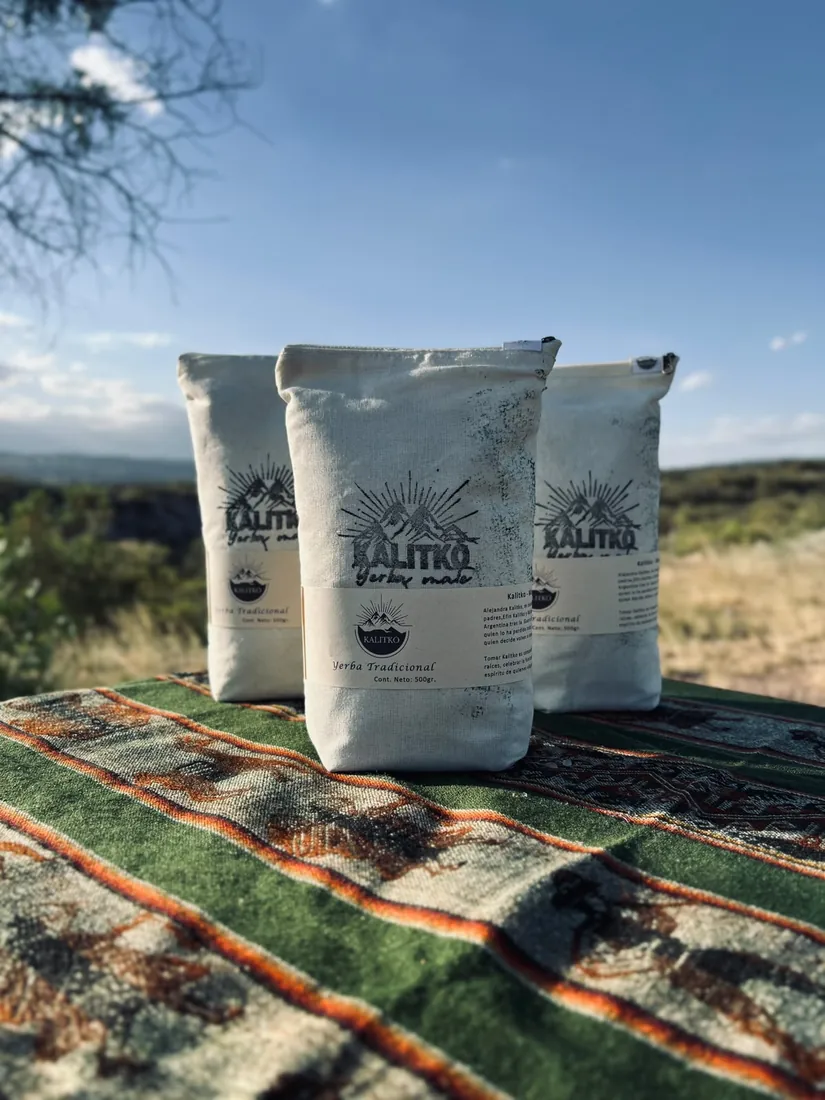 Bolsa de yerba Kalitko junto a un mate sobre un tejido en un entorno natural